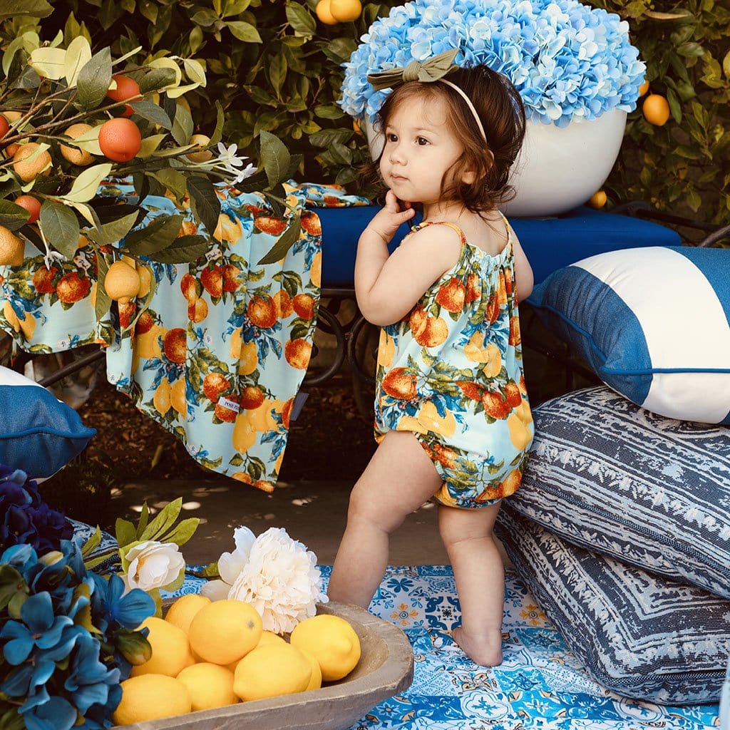 Baby posing wearing Lucia Sleeveless Bubble Romper