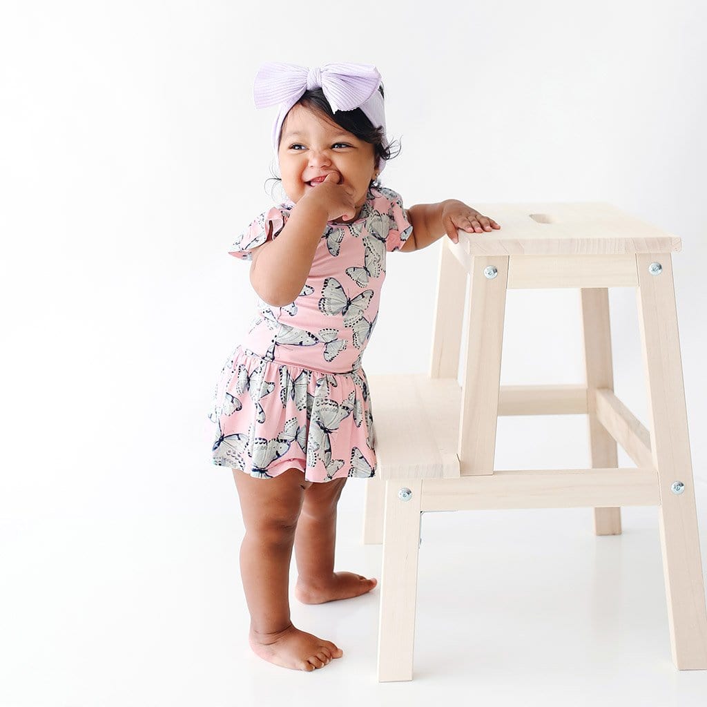 Baby wearing Beatrice Ruffled Cap Sleeve Twirl Skirt Bodysuit with butterfly pattern