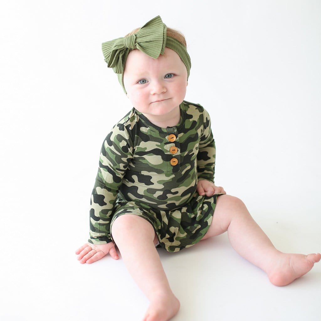 Baby sitting wearing Cadet Long Sleeve Henley Twirl Skirt Bodysuit