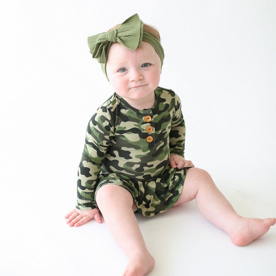 Baby sitting wearing Cadet Long Sleeve Henley Twirl Skirt Bodysuit