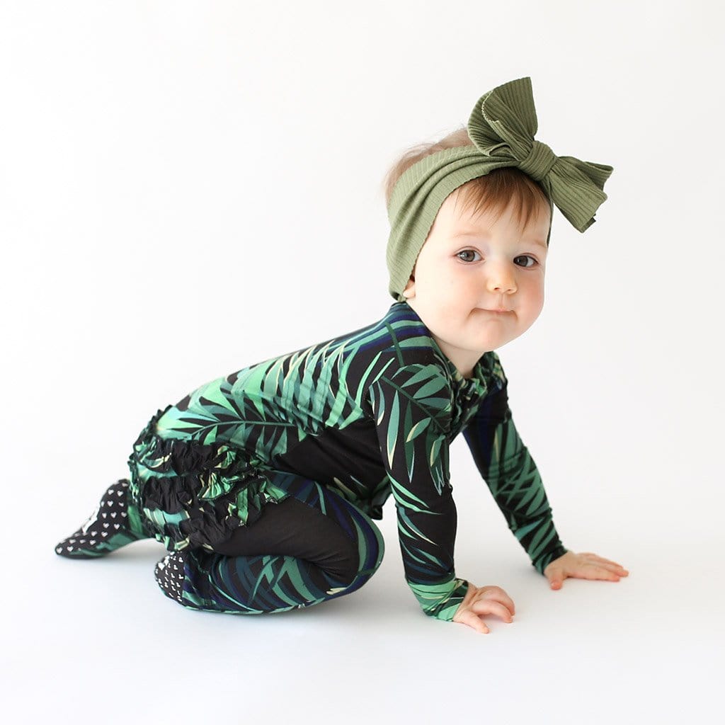 Crawling baby wearing Cooper Footie Ruffled Zippered One Piece with leaf design