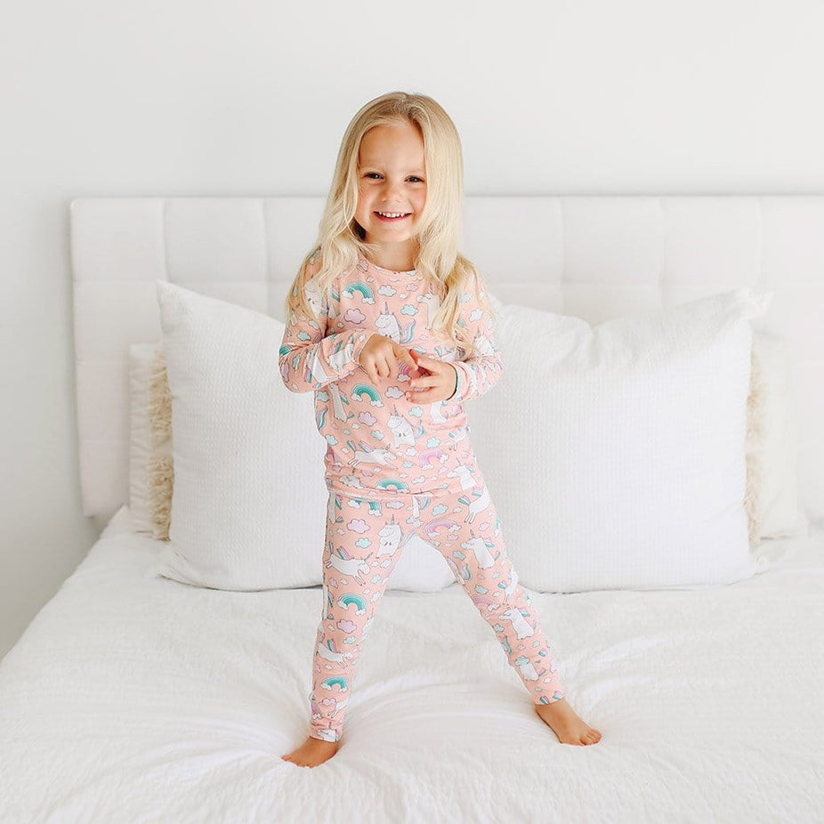 Toddler wearing Olive Long Sleeve Pajamas with unicorn pattern