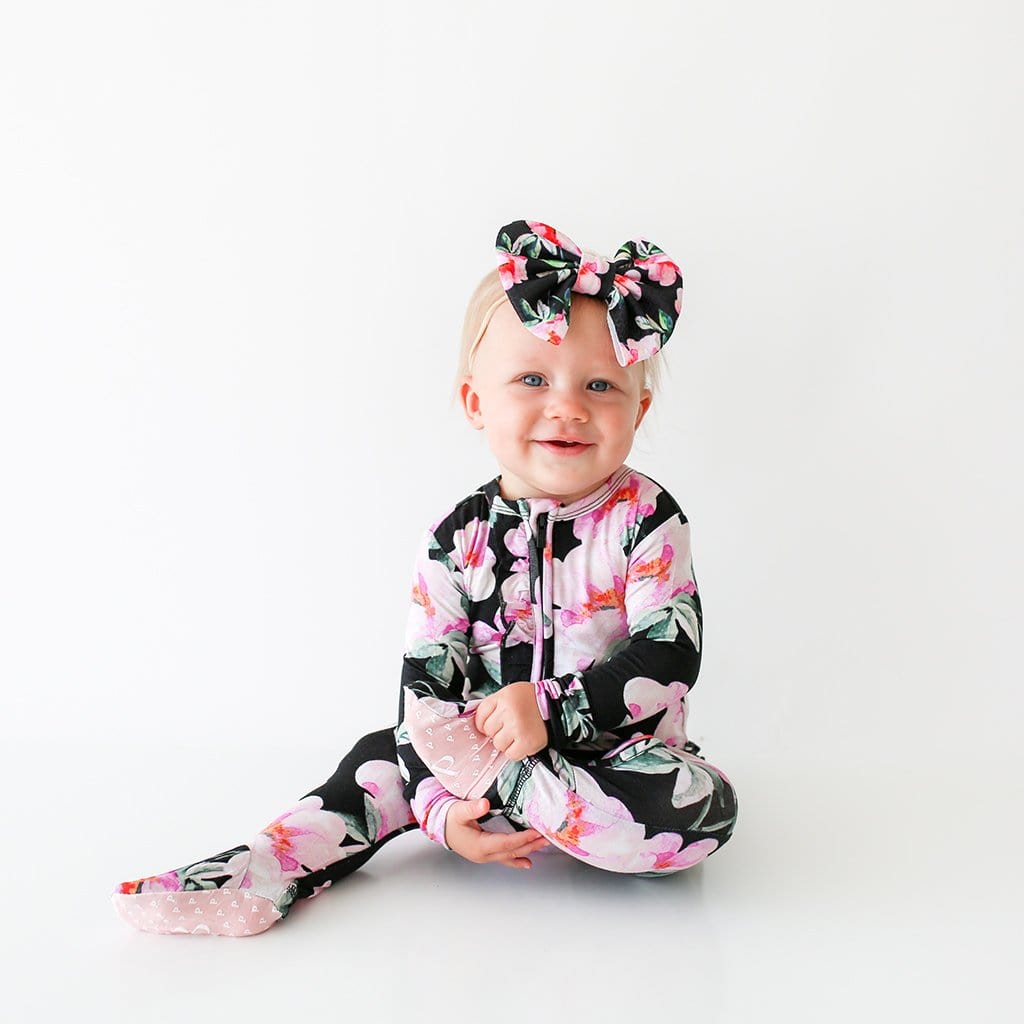 Sitting baby wearing Tenni Footie Ruffled Zippered One Piece