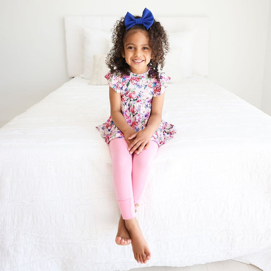 Sitting toddler wearing Vivienne Ruffled Cap Sleeve Peplum Legging Set