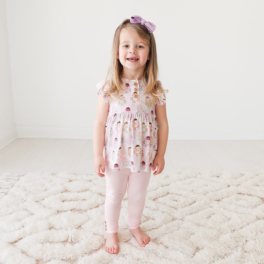 Toddler wearing Matryoshka Ruffled Cap Sleeve Henley Peplum Legging Set
