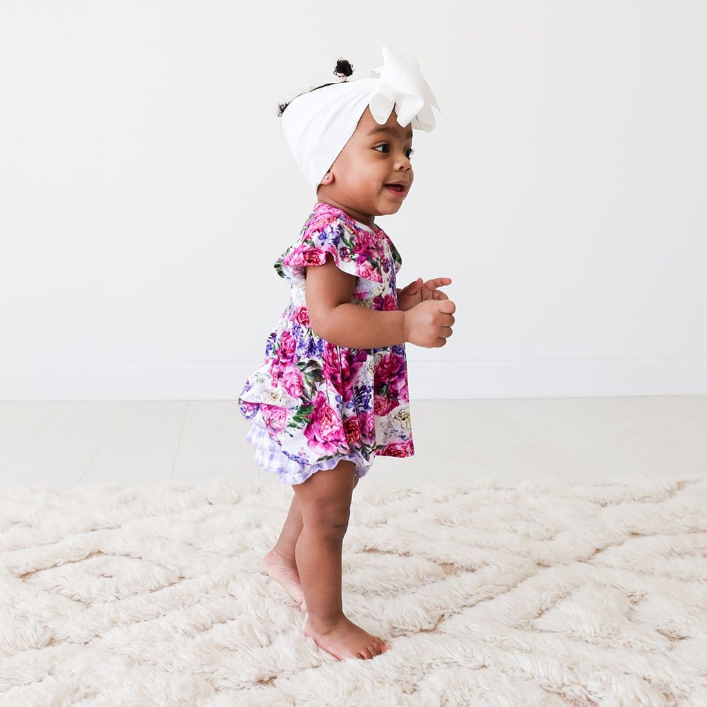 Walking baby wearing Floral Bella Ruffled Cap Sleeve Peplum Ruffled Bummie Set