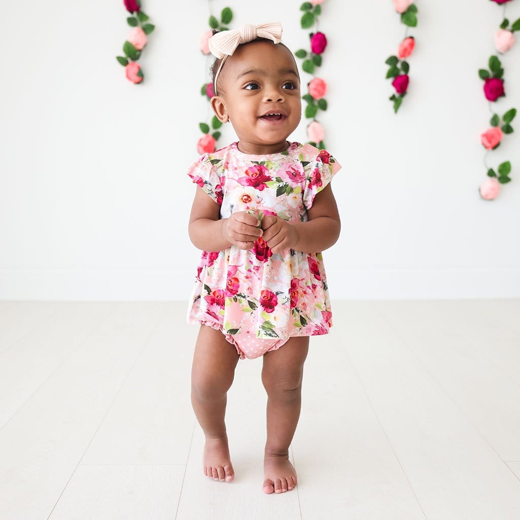Baby wearing Marlene Ruffled Cap Sleeve Peplum Ruffled Bummie Set