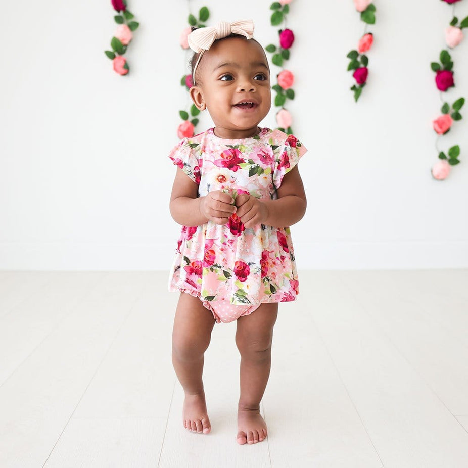 Baby wearing Marlene Ruffled Cap Sleeve Peplum Ruffled Bummie Set