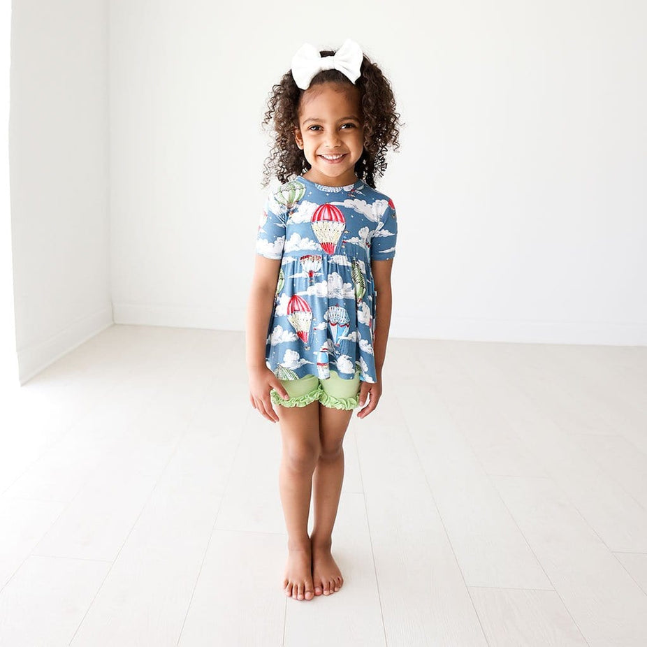 Toddler girl wearing Tanner Short Sleeve Peplum Ruffled Short Set