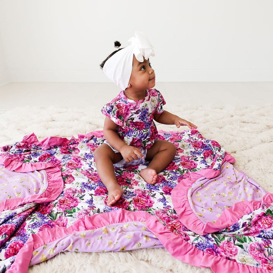 Baby sitting on Bella & Gianna Ruffled Luxe Patoo