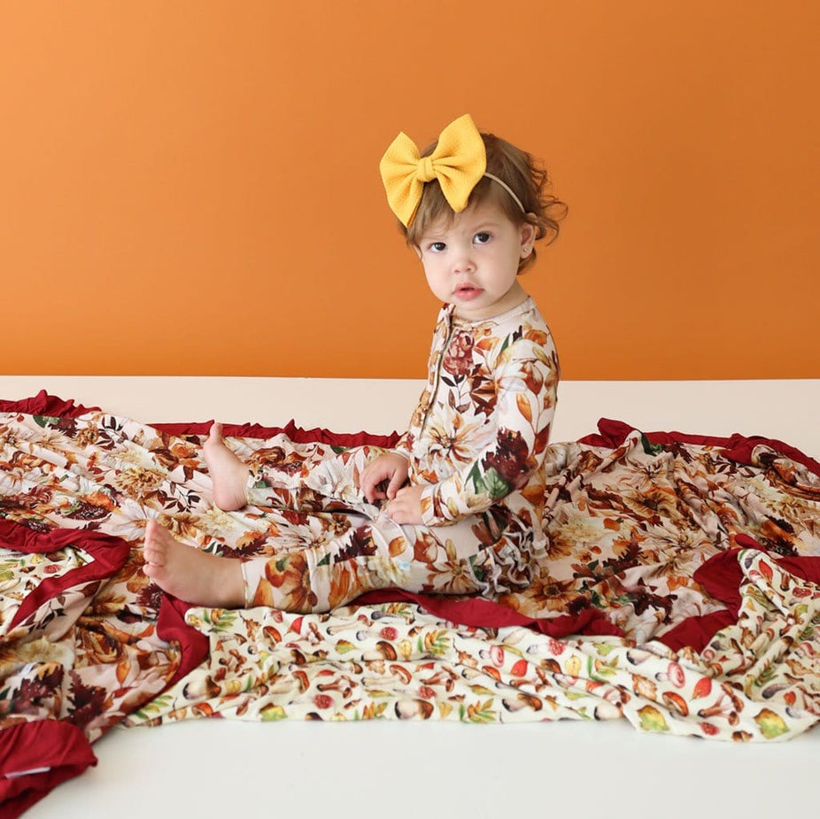 Baby girl sitting on Floral Baby Blanket | Luxe Patoo™ | Julieta & Alba