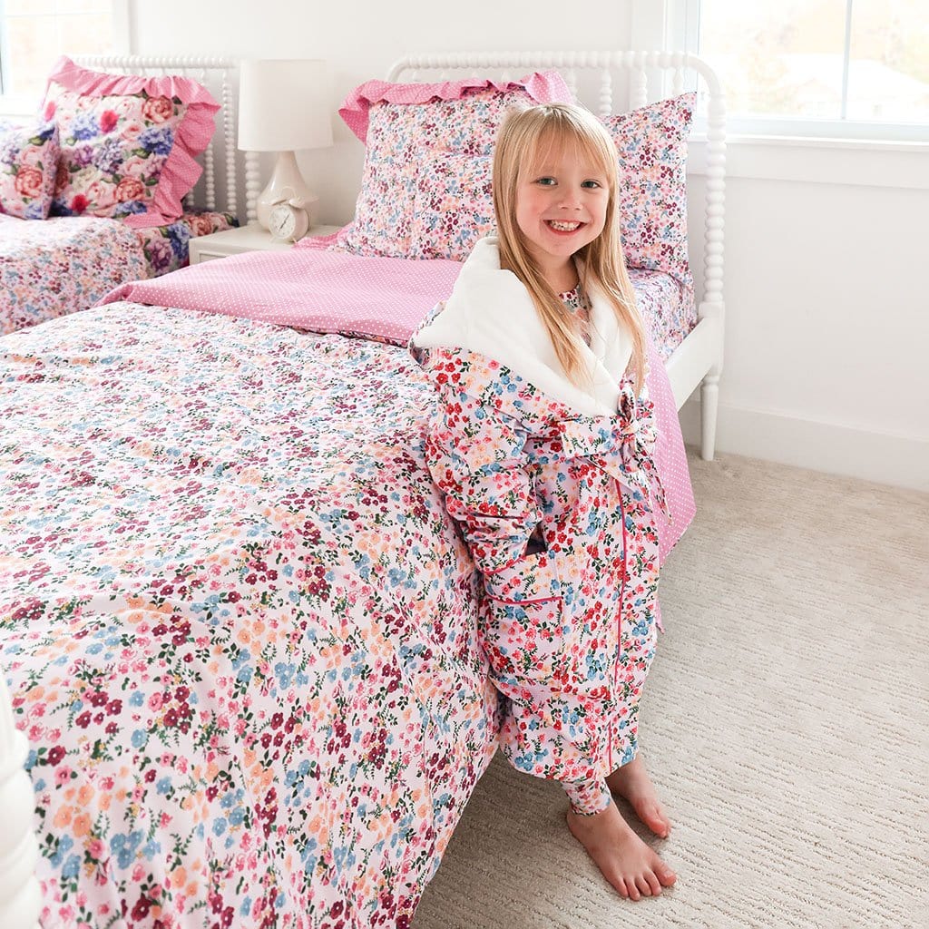 Little girl standing in matching Floral pink robe next to bed with Floral Pink Duvet Cover Aldona By Posh Peanut