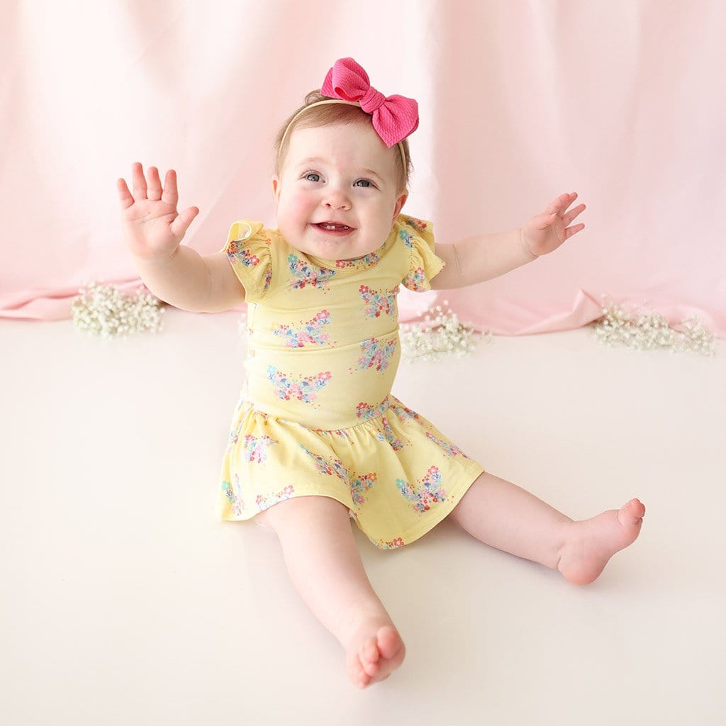 Baby wearing Keira Ruffled Cap Sleeve Twirl Skirt Bodysuit