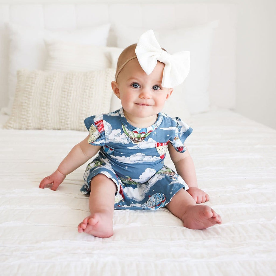 Baby girl wearing Tanner Ruffled Cap Sleeve Twirl Skirt Bodysuit