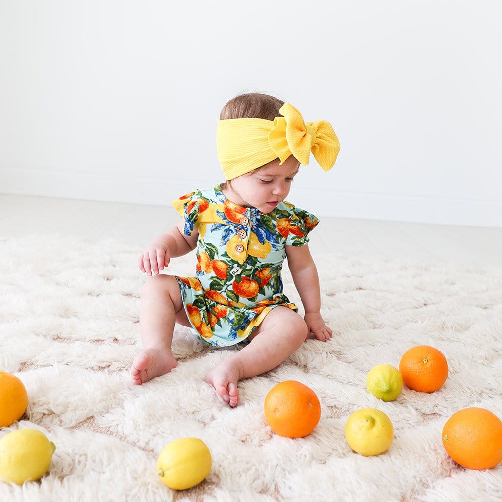 Baby wearing Lucia Ruffled Cap Sleeve Henley Twirl Skirt Bodysuit