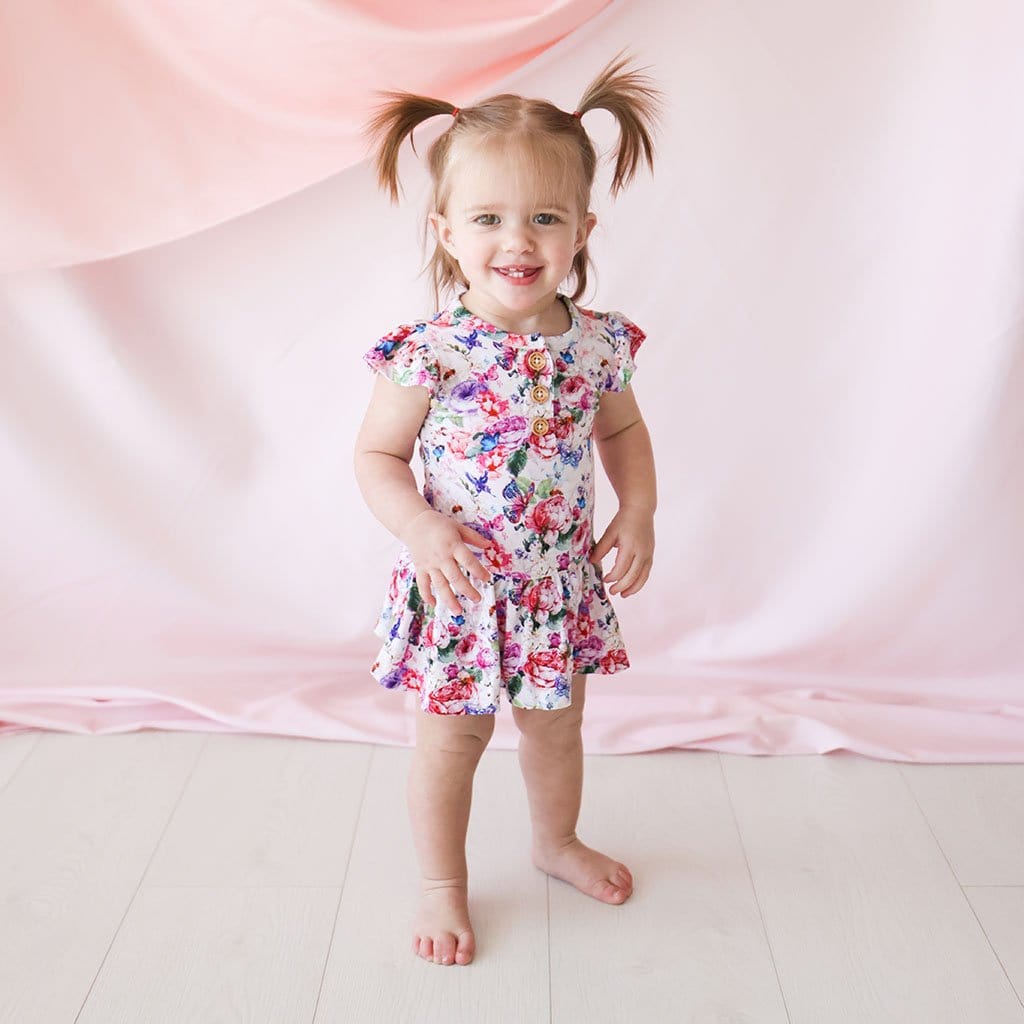 Baby wearing Vivienne Ruffled Cap Sleeve Henley Twirl Skirt Bodysuit