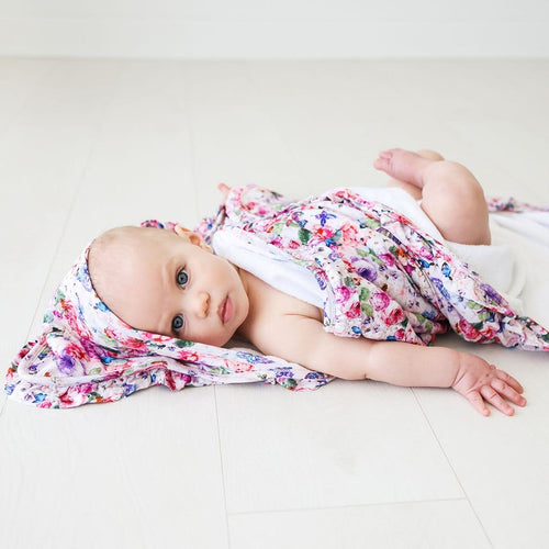 Baby covered in Vivienne Ruffled Hooded Towel