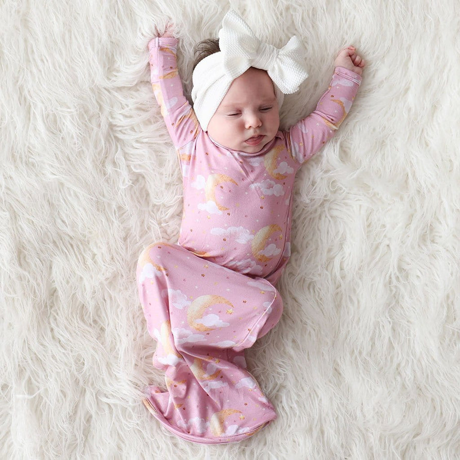Baby Girl Stretching in Moon Pink Zippered Baby Gown