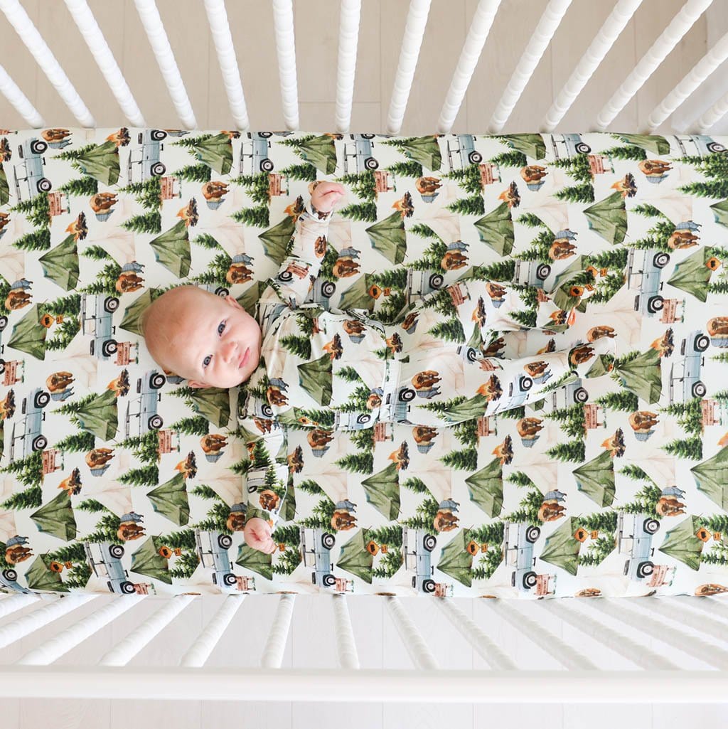 Baby in Crib with Camping Crib Sheet Camp Posh Peanut