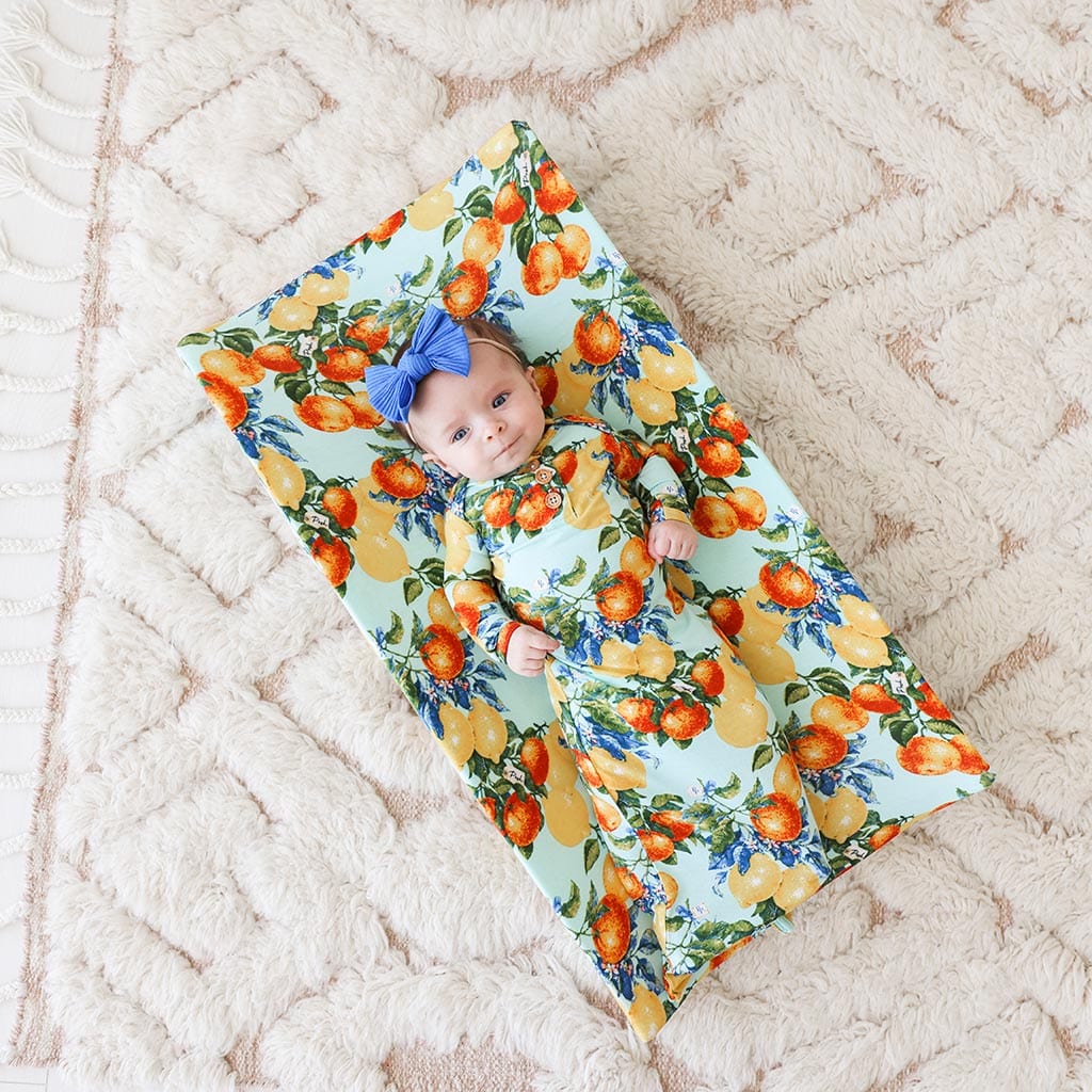 Baby lying on Lucia Pad Cover