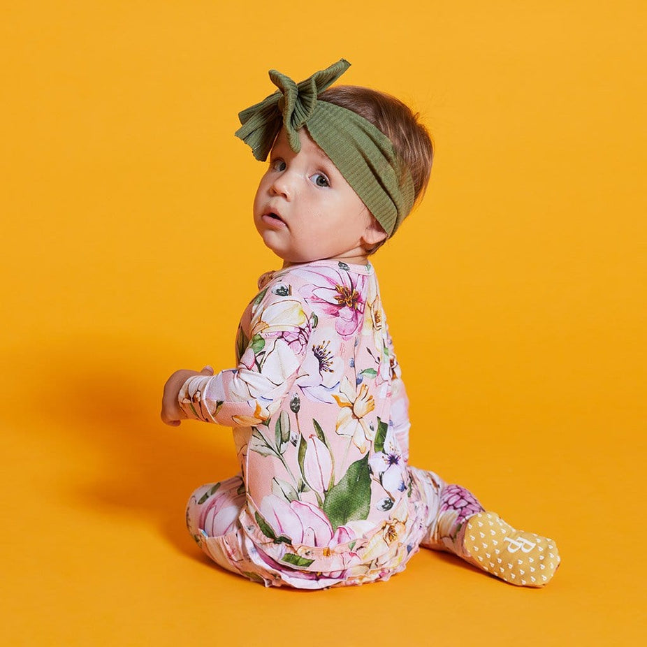 Baby wearing Margot Footie Ruffled Zippered One Piece in Floral print