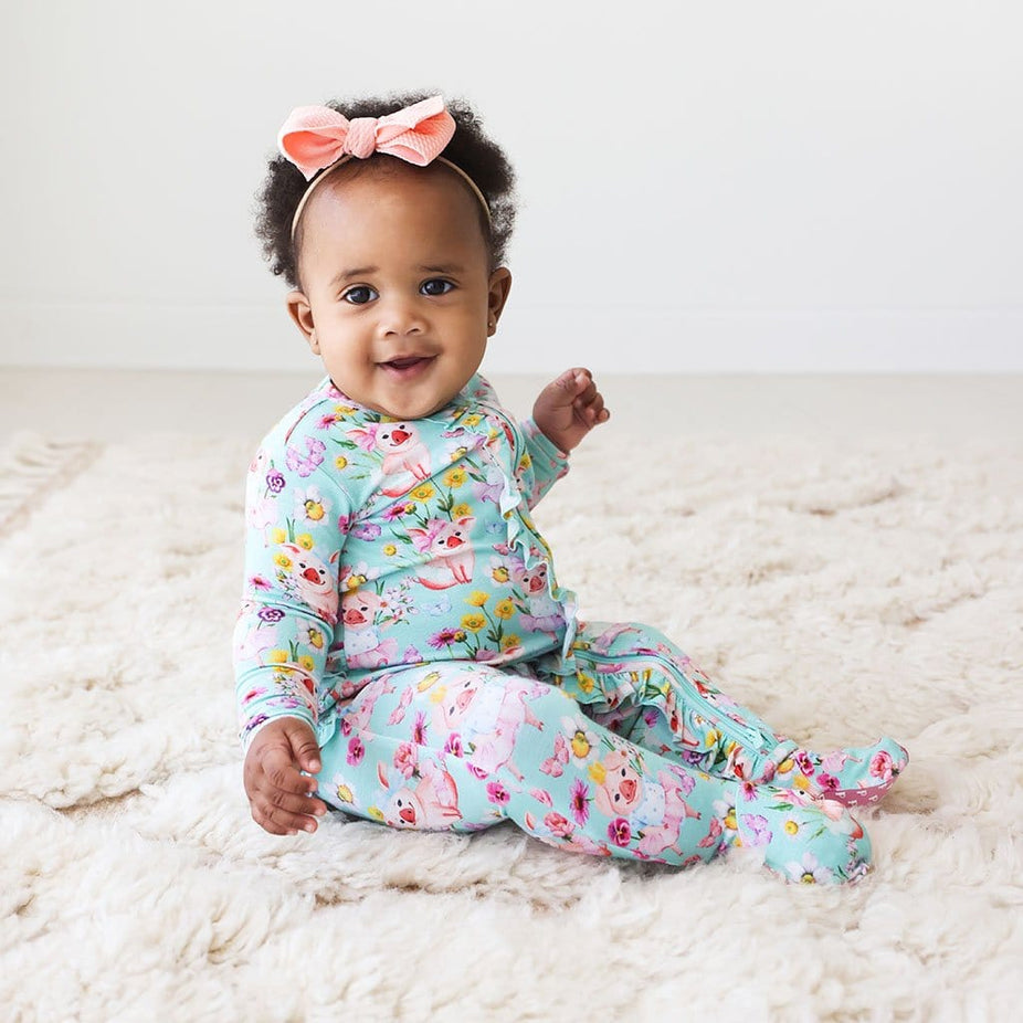 Baby wearing floral printed Missy Footie Ruffled Zippered One Piece
