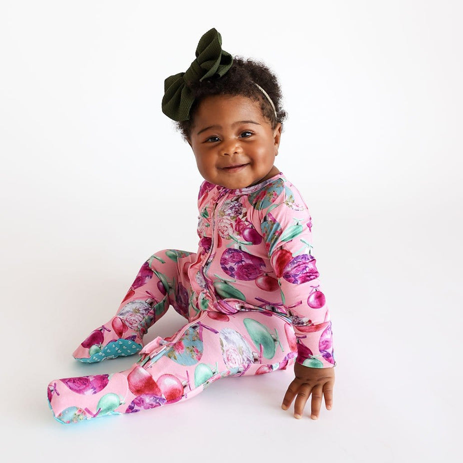 baby girl sitting and smiling in Christmas Baby Girl Footie | Posh Ornaments