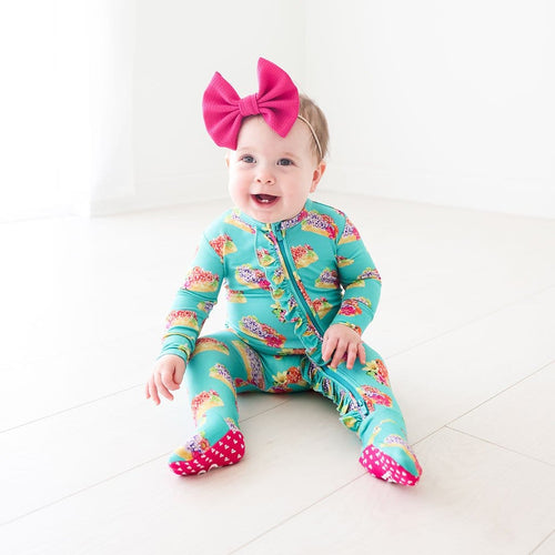 Baby wearing Valentina Footie Ruffled Zippered One Piece in flower print