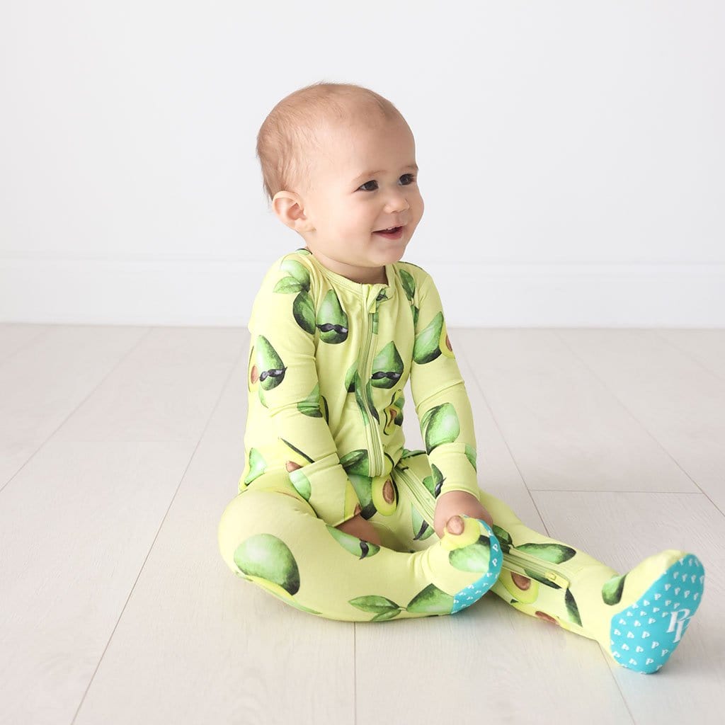 Baby sitting wearing Franco Footie Zippered One Piece