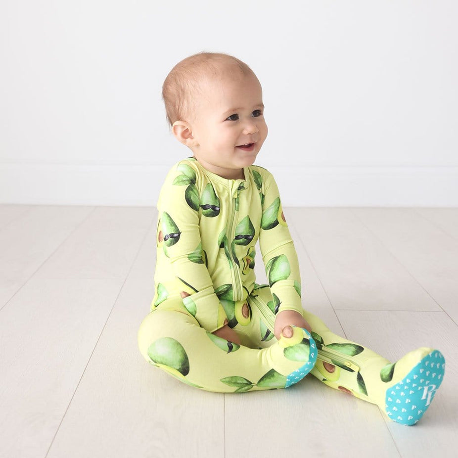 Baby sitting wearing Franco Footie Zippered One Piece