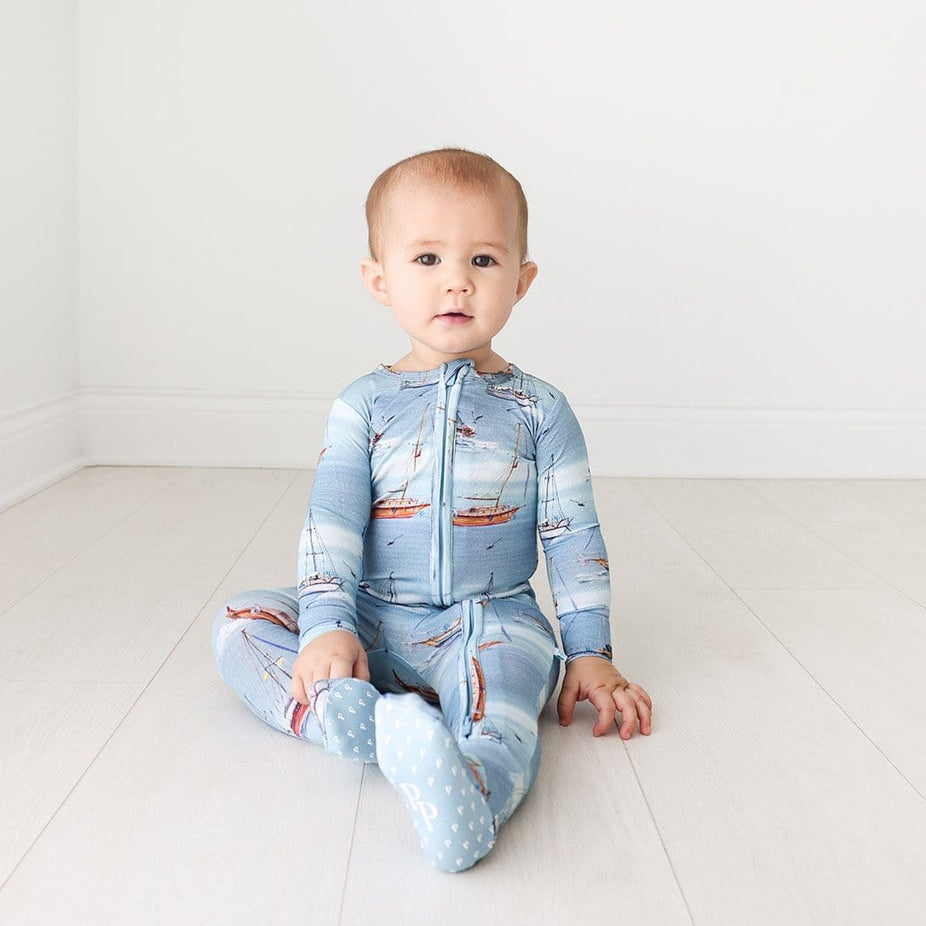 Baby boy wearing Skip Footie Zippered One Piece