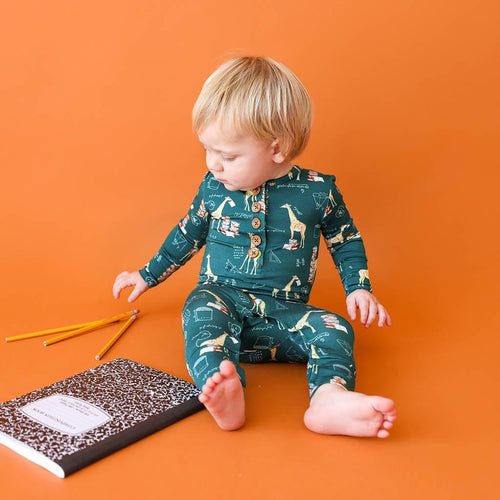 Sitting baby wearing Stanley Long Sleeve Henley Romper