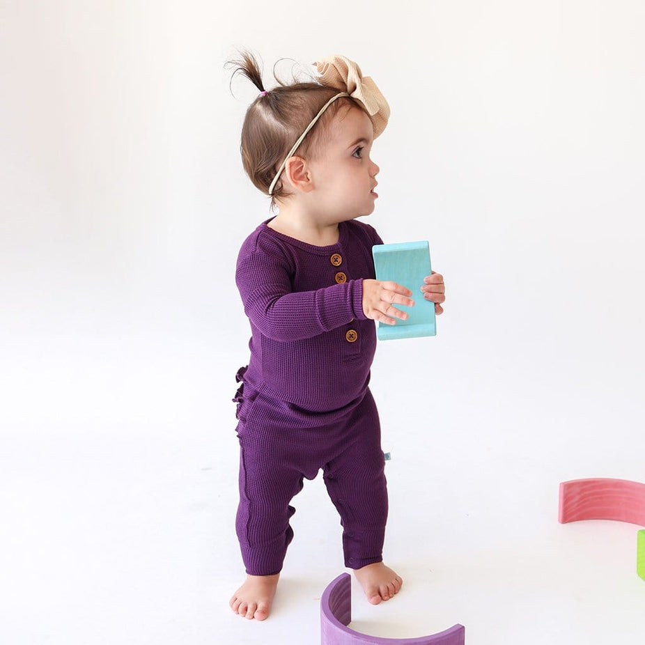 Baby with toy in Posh Peanut Plum Waffle Knit Baby Girl Romper