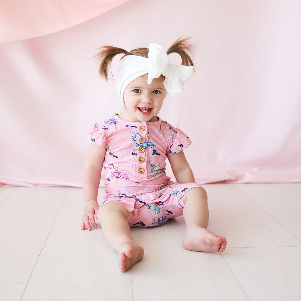 Baby wearing Claudine Ruffled Cap Sleeve Henley Short Romper