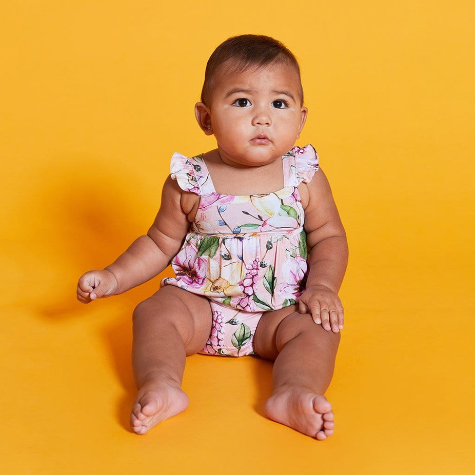 Baby wearing Margot Ruffled Cap Sleeve Bubble Romper