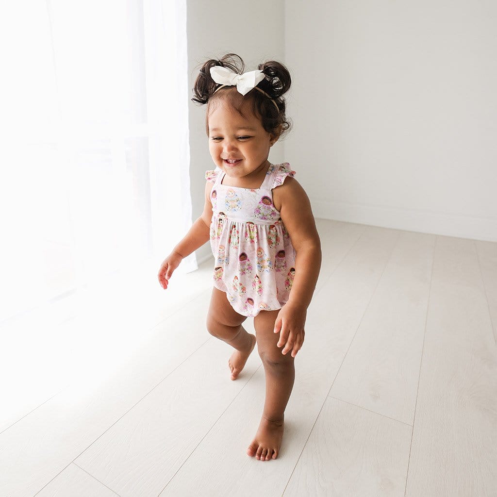 Toddler wearing Matryoshka Pink Ruffled Cap Sleeve Bubble Romper