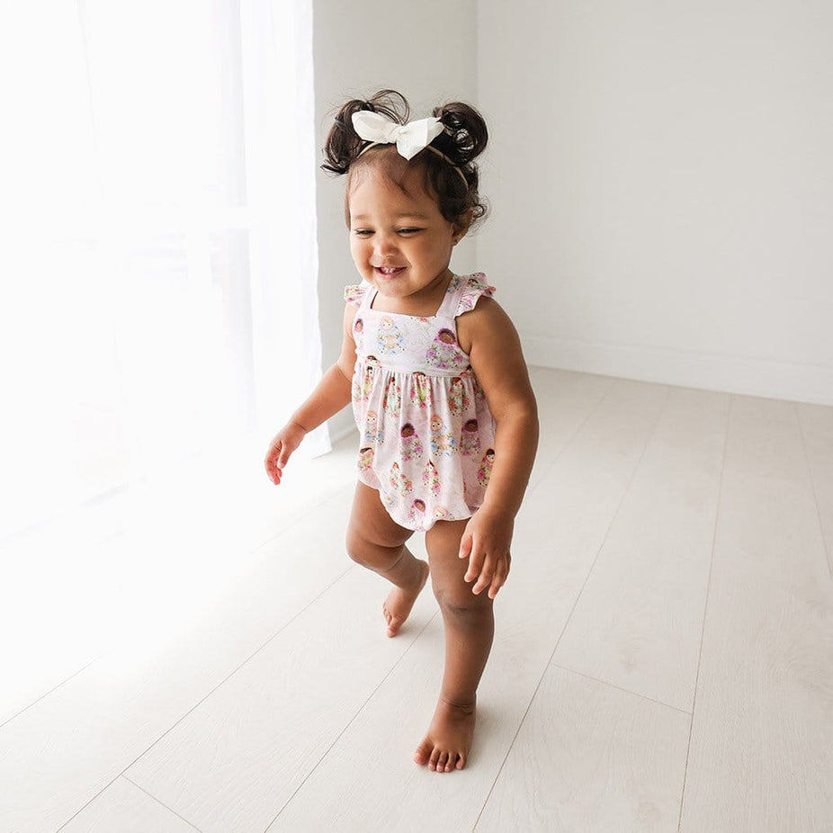 Toddler wearing Matryoshka Pink Ruffled Cap Sleeve Bubble Romper