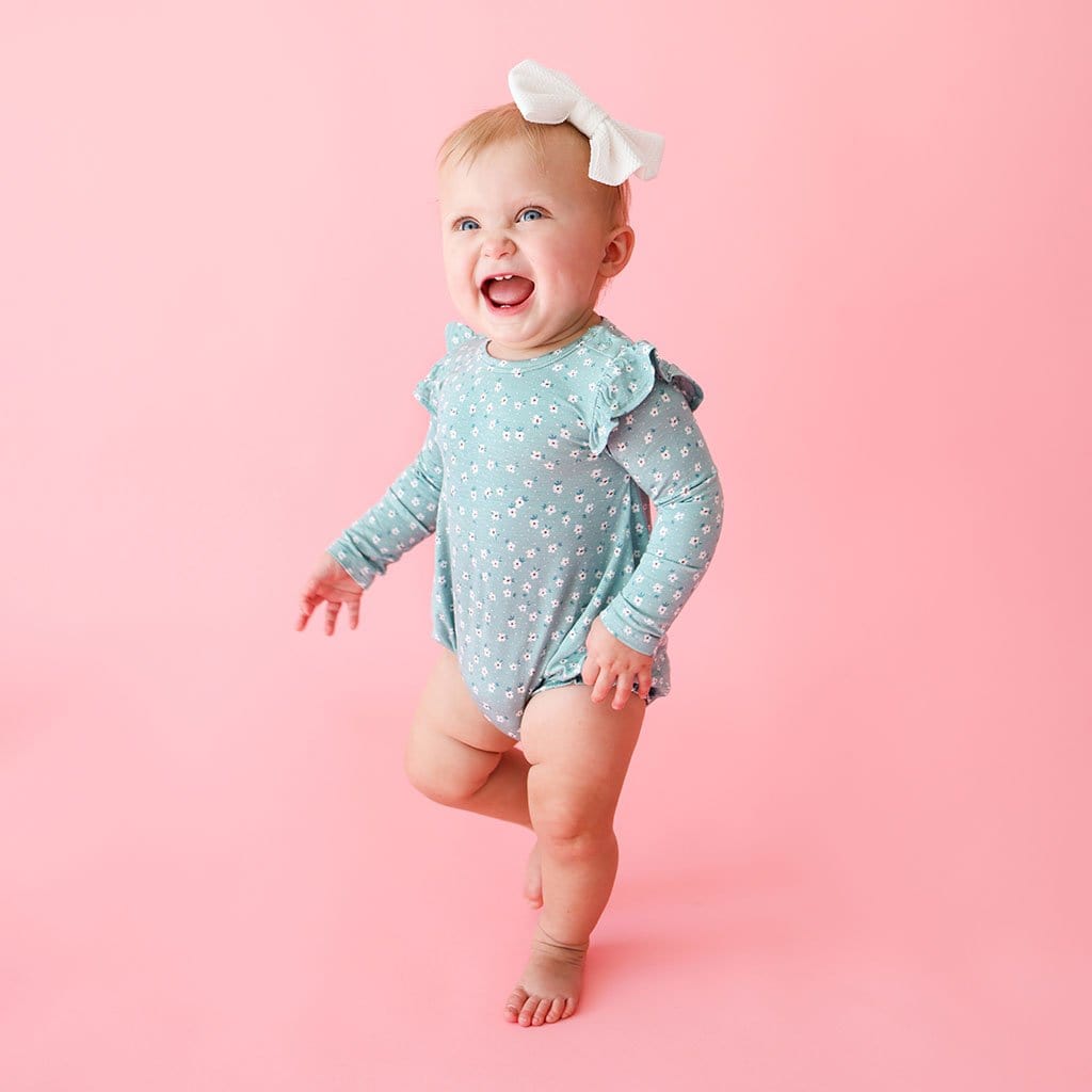 Baby Smiling in Margarite Floral Baby Girl Bubble Romper