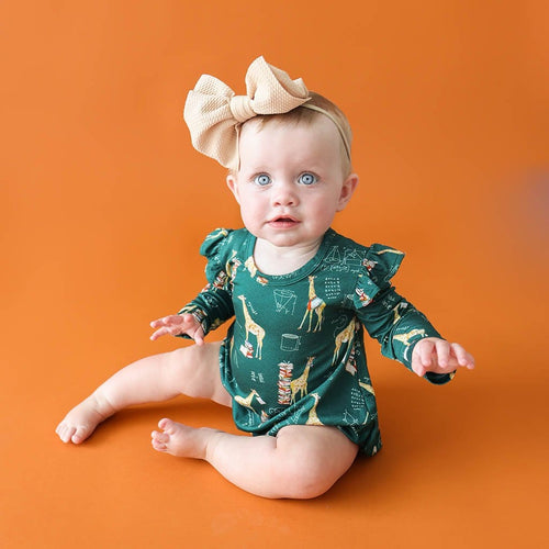 Baby wearing ribbon on Stanley Ruffled Long Sleeve Bubble Romper