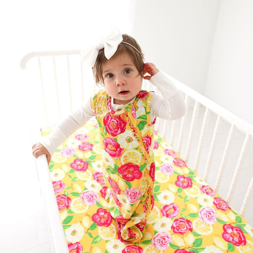 Baby wearing Annika Sleeveless Ruffled Sleep Bag 1.0 Tog in floral print