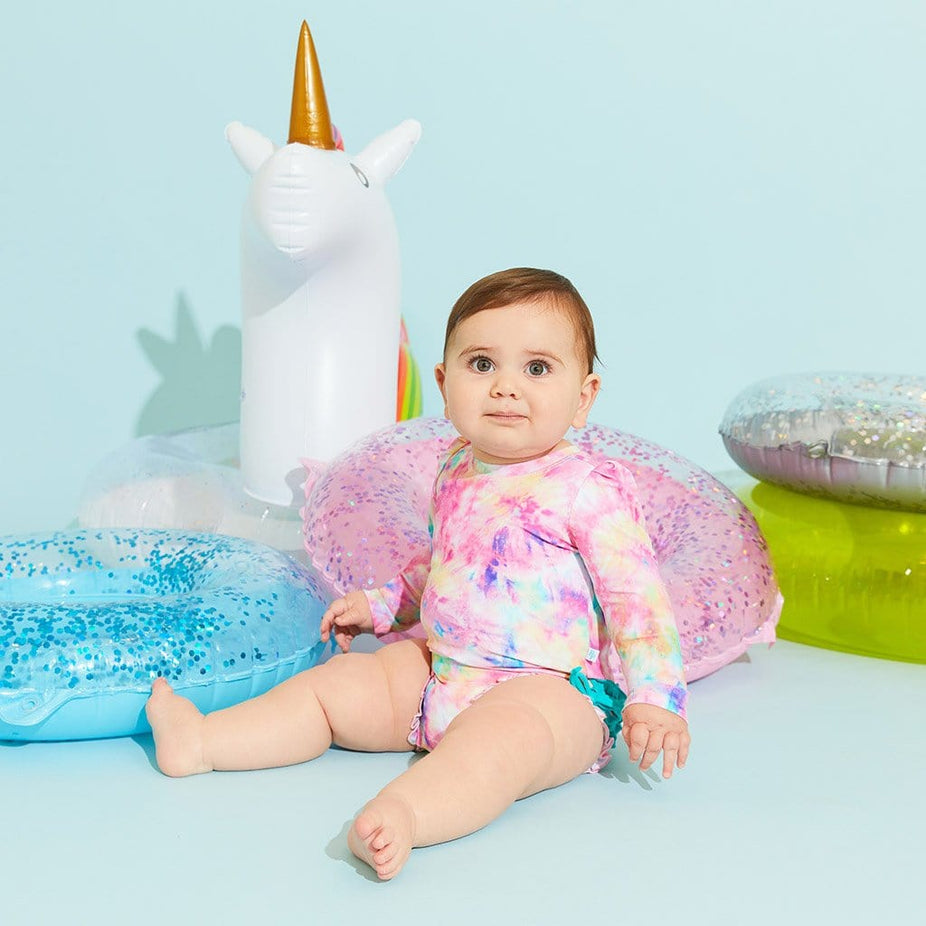 Baby wearing Joplin Long Sleeve Ruffled Rash Guard Swimsuit