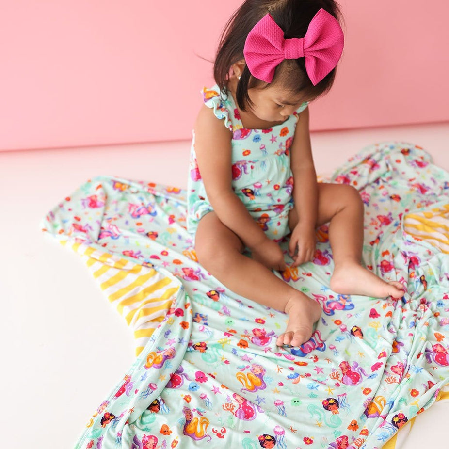 Baby in pink ribbon wearing Kai & Yellow Stripe Patoo