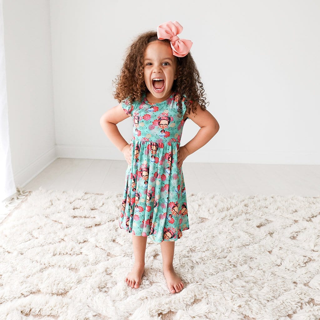 Toddler wearing Frida Kahlo Ruffled Cap Sleeve Twirl Dress