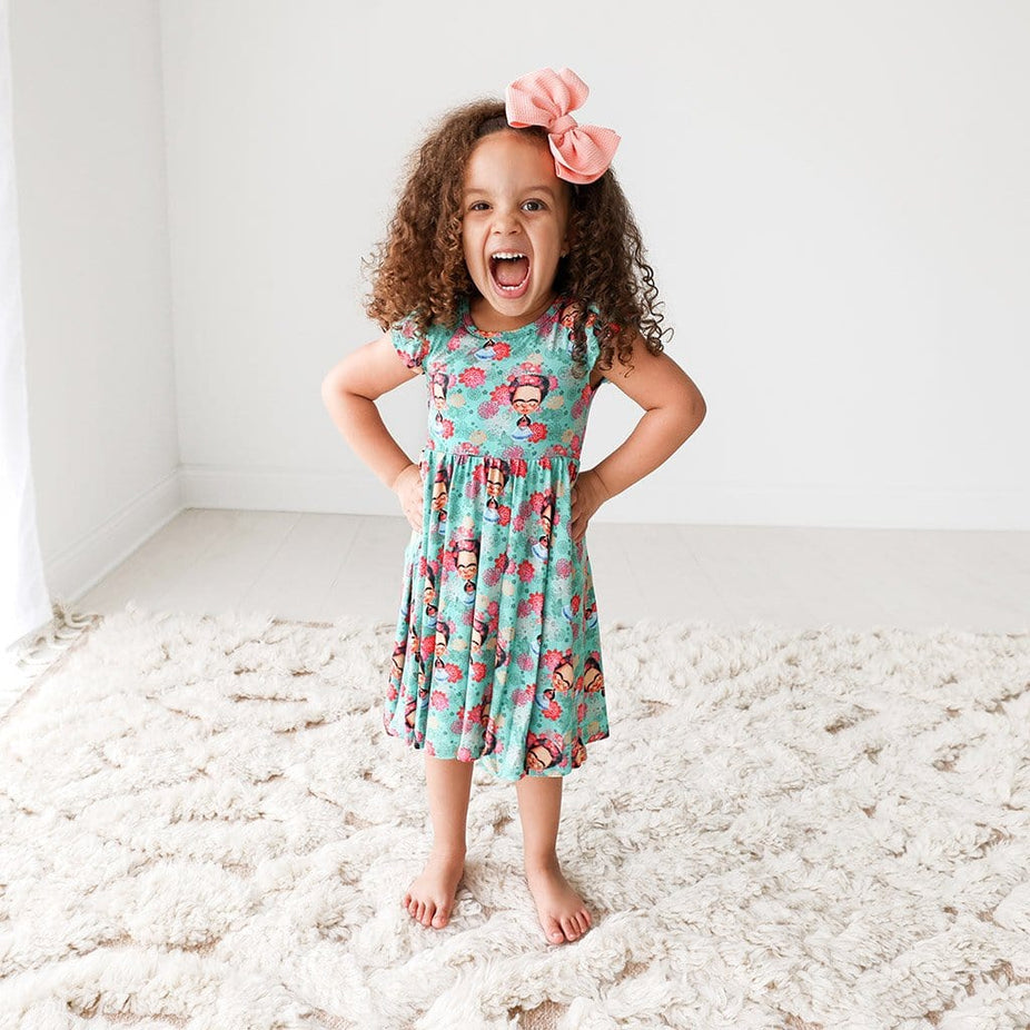 Toddler wearing Frida Kahlo Ruffled Cap Sleeve Twirl Dress