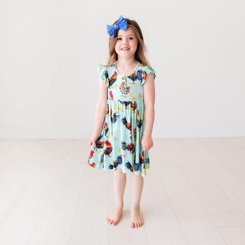 Toddler wearing Rhett Ruffled Cap Sleeve Henley Twirl Dress with chicken print