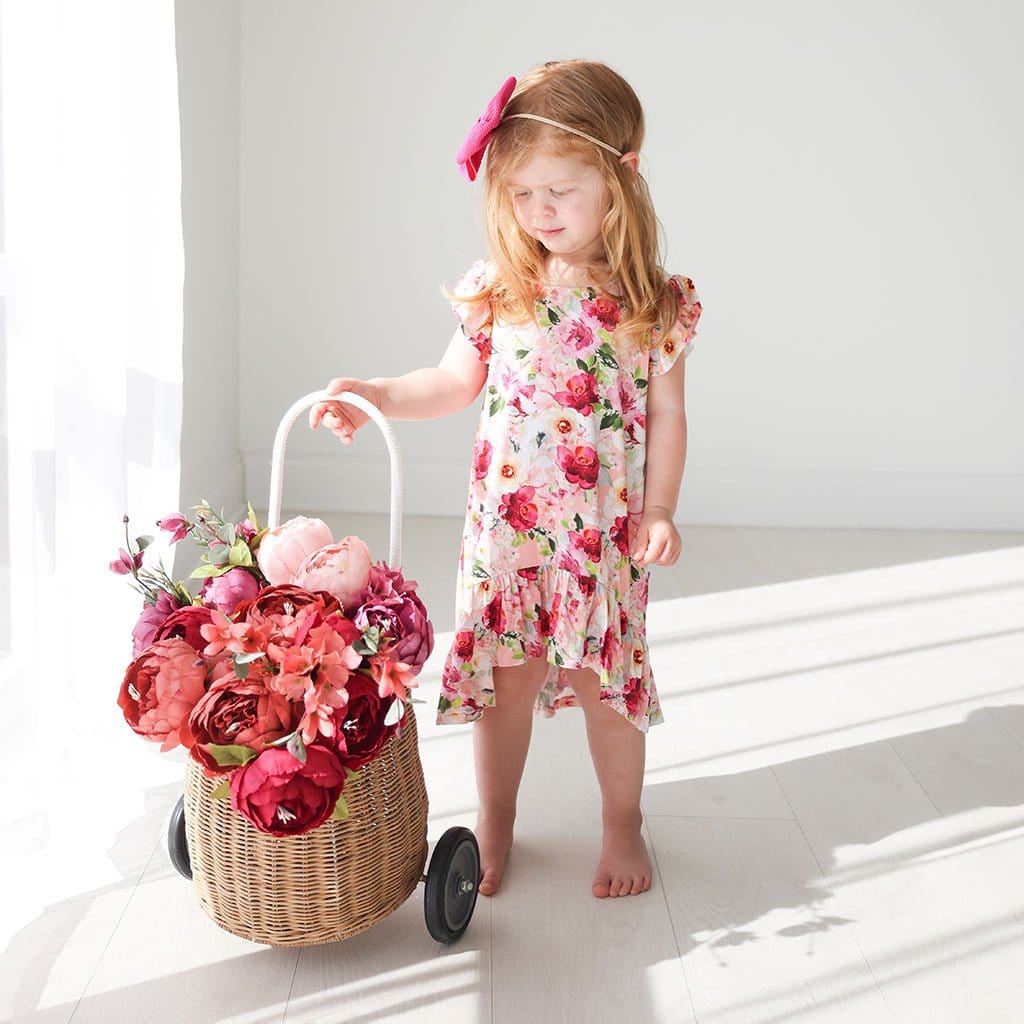 Baby holding trolley wearing Marlene Ruffled Cap Sleeve Hi-Low Dress
