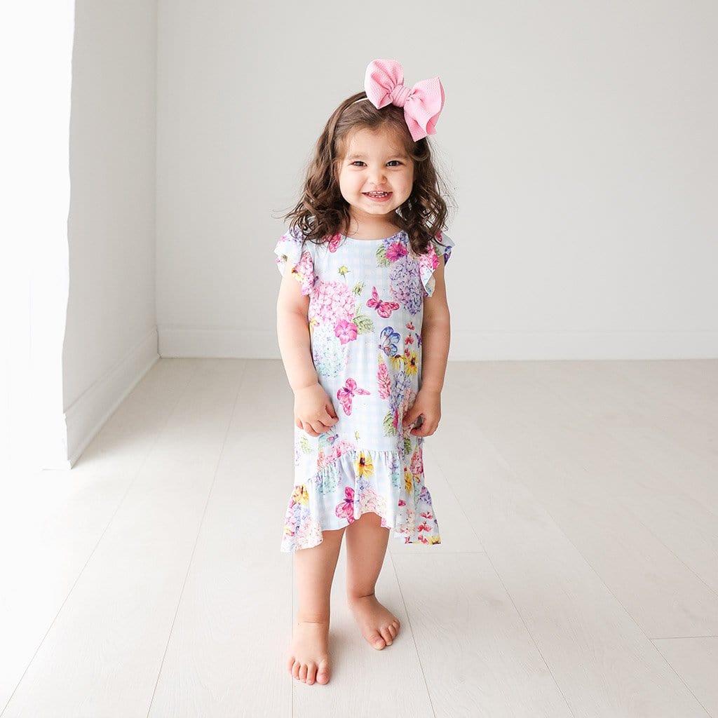 Baby wearing Nicolette Ruffled Cap Sleeve Hi-Low Dress