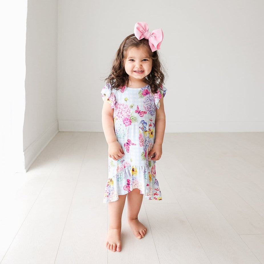 Baby wearing Nicolette Ruffled Cap Sleeve Hi-Low Dress